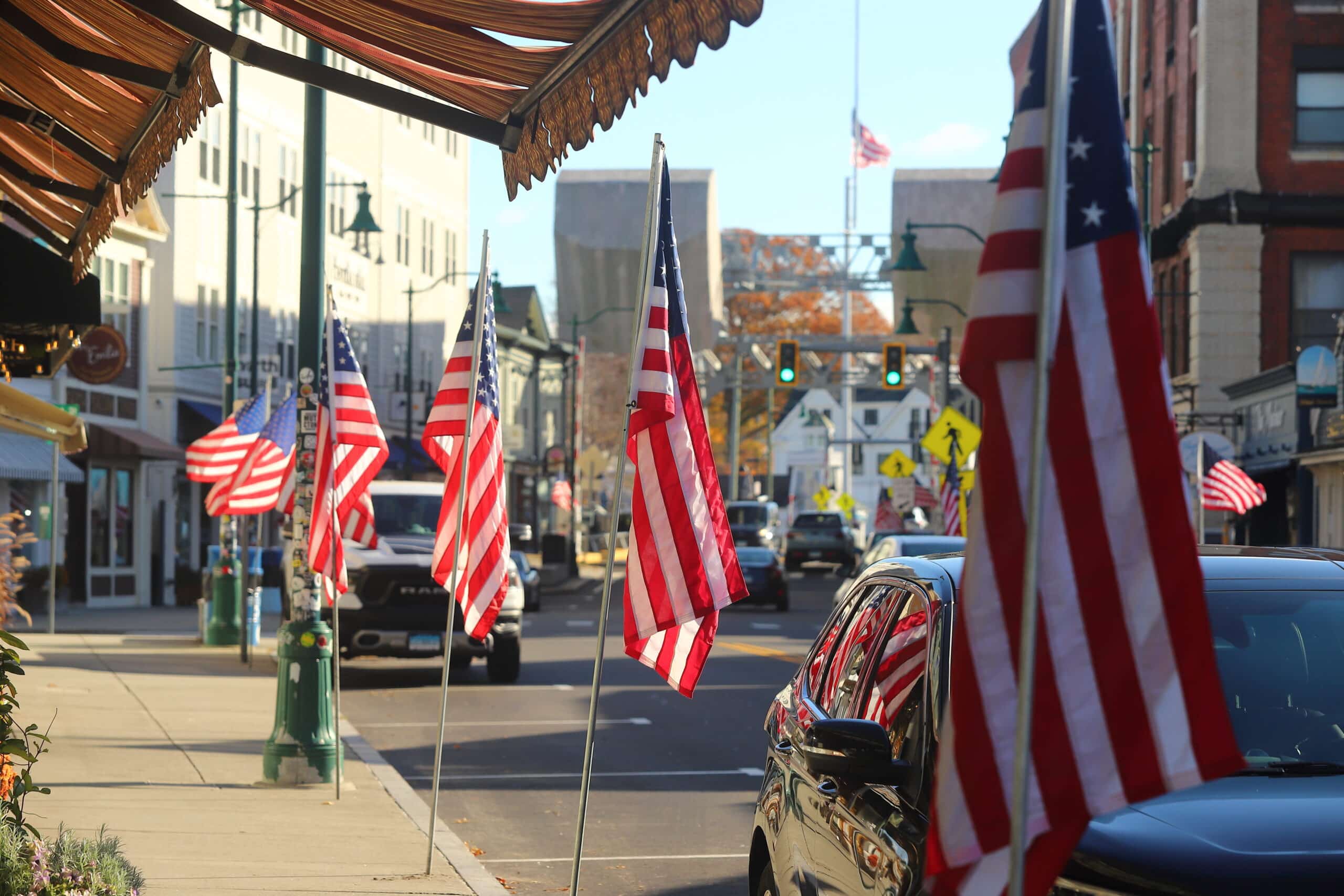 American flag waving above Mystic CT Liberty Pole Park historic landmark